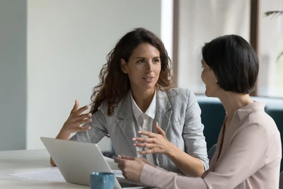 Two Business Women talking about work 