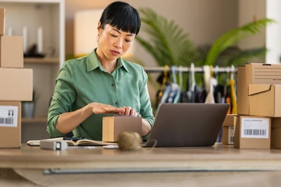 Ecommerce business woman packing boxes