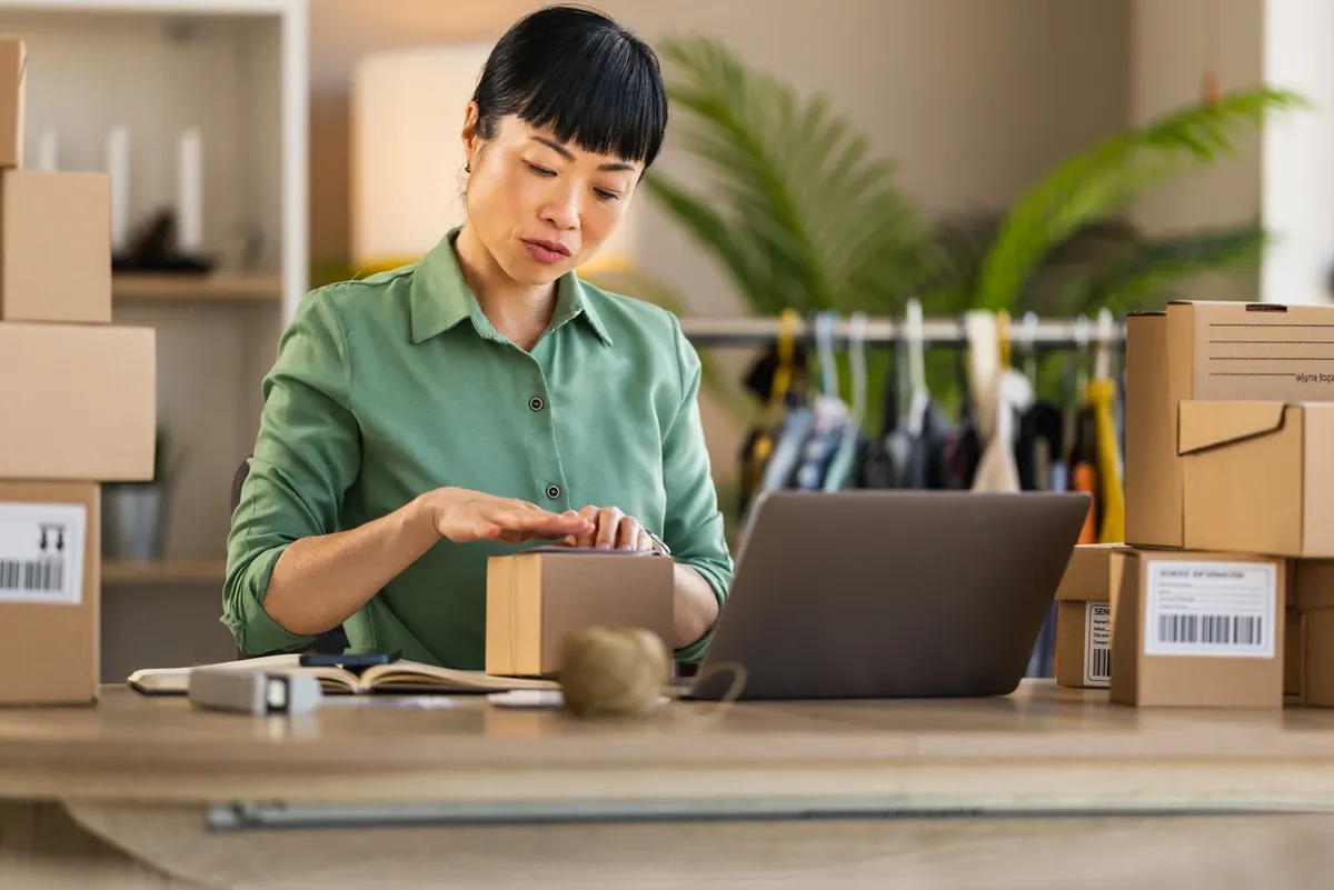 Ecommerce business woman packing boxes